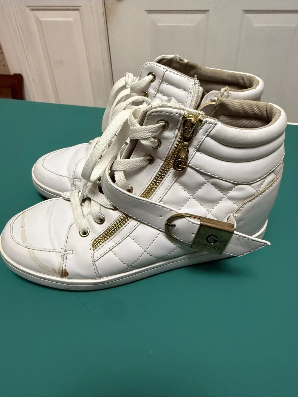 GUESS High-Top Wedge Sneakers in white faux leather.